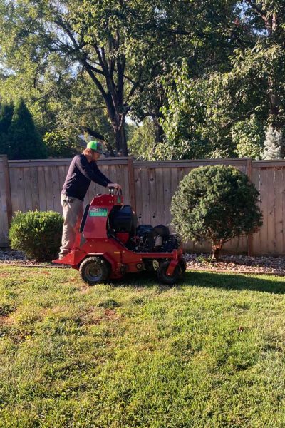 lawn technician aerating backyard